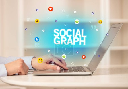 Photo for Freelance woman using laptop with SOCIAL GRAPH inscription, Social media concept - Royalty Free Image