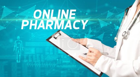 Photo for Doctor writes notes on the clipboard with ONLINE PHARMACY inscription, medical diagnosis concept - Royalty Free Image