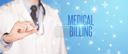 Photo for Close-up of a doctor giving a pill with MEDICAL BILLING inscription, medical concept - Royalty Free Image
