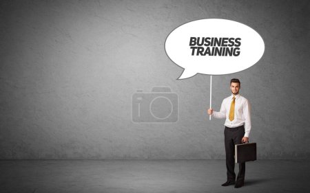 Photo for Young business person in casual holding road sign with BUSINESS TRAINING inscription, new business idea concept - Royalty Free Image