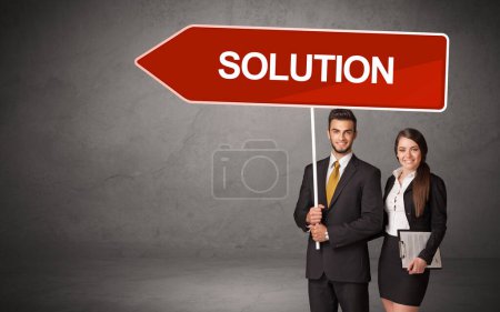 Young business person in casual holding road sign with SOLUTION inscription, new business direction concept