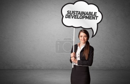 Young business person in casual holding road sign with SUSTAINABLE DEVELOPMENT inscription, new business idea concept