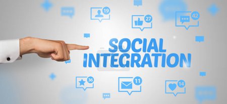 Photo for Close-Up of cropped hand pointing at SOCIAL INTEGRATION inscription, social networking concept - Royalty Free Image