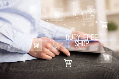 Young person makes a purchase through online shopping application with DUTY-FREE SHOP inscription