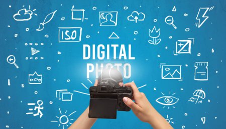 Photo for Hand taking picture with digital camera and DIGITAL PHOTO inscription, camera settings concept - Royalty Free Image