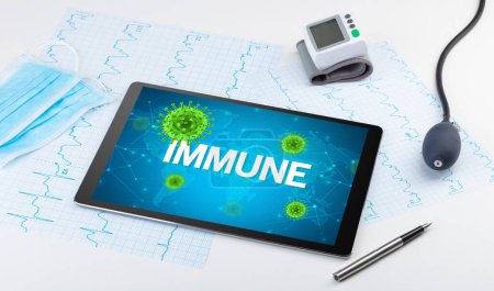 Photo for Close-up view of a tablet pc with IMMUNE inscription, microbiology concept - Royalty Free Image