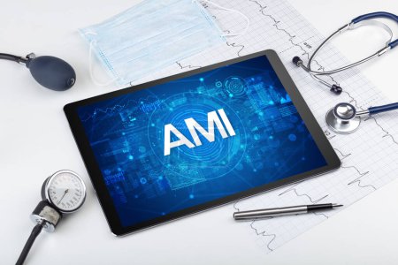 Close-up view of a tablet pc with AMI abbreviation, medical concept