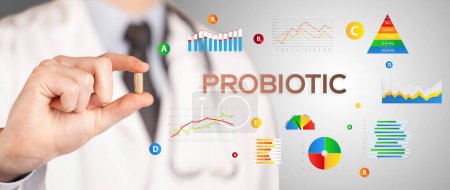 Photo for Nutritionist giving you a pill with PROBIOTIC inscription, healthy lifestyle concept - Royalty Free Image