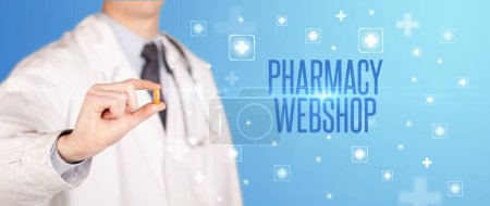 Photo for Close-up of a doctor giving a pill with PHARMACY WEBSHOP inscription, medical concept - Royalty Free Image