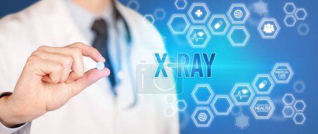 Photo for Close-up of a doctor giving you a pill with X-RAY inscription, medical concept - Royalty Free Image
