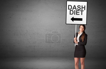 business person holding a traffic sign with DASH DIET inscription, new idea concept