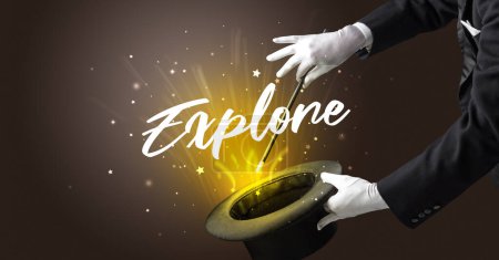 Photo for Magician is showing magic trick with Explore inscription, traveling concept - Royalty Free Image