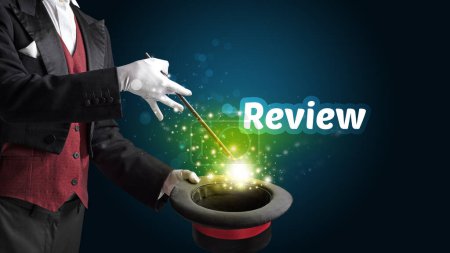 Photo for Magician is showing magic trick with Review inscription, educational concept - Royalty Free Image