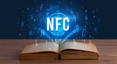 Téléchargez les photos : Inscription NFC issue d'un livre ouvert, concept de technologie numérique - en image libre de droit