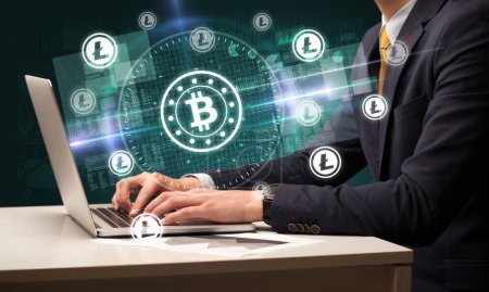 Photo for Business hand working in stock market with bitcoin icons coming out from laptop screen - Royalty Free Image