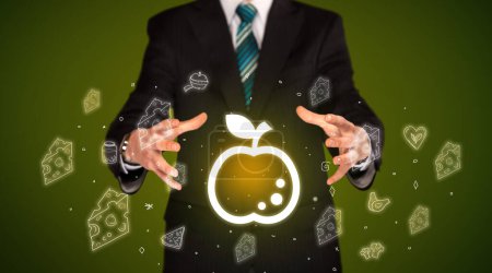 Photo for Hand holding apple icon, healthy food delivery concept - Royalty Free Image