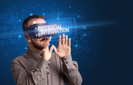 Photo for Businessman looking through Virtual Reality glasses with SOCIAL INTEGRATION inscription, social networking concept - Royalty Free Image