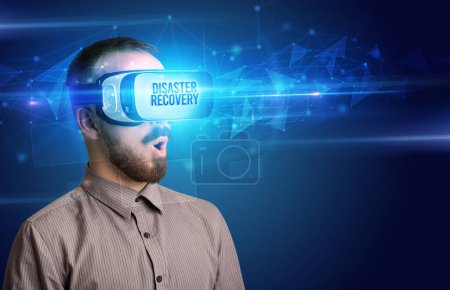 Photo for Businessman looking through Virtual Reality glasses with DISASTER RECOVERY inscription, cyber security concept - Royalty Free Image