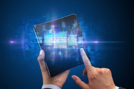 Téléchargez les photos : Homme d'affaires tenant un smartphone pliable avec inscription ENERGY, nouveau concept technologique - en image libre de droit