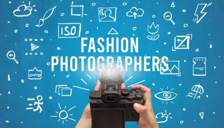 Photo for Hand taking picture with digital camera and FASHION PHOTOGRAPHERS inscription, camera settings concept - Royalty Free Image