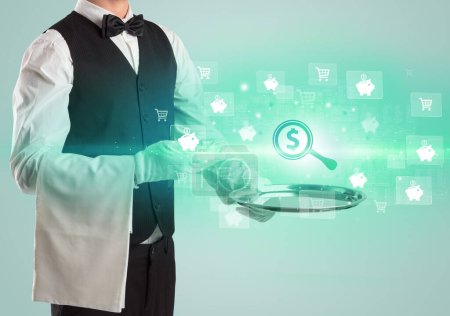 Photo for Young waiter serving magnifying glass with a dollar sign icons concept on tray, new business model concept - Royalty Free Image