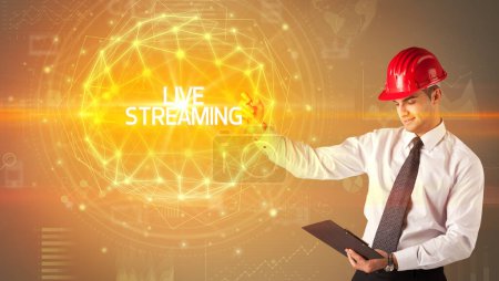 Photo for Handsome businessman with helmet drawing LIVE STREAMING inscription, social construction concept - Royalty Free Image