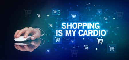 hand holding wireless peripheral with SHOPPING IS MY CARDIO inscription, online shopping concept