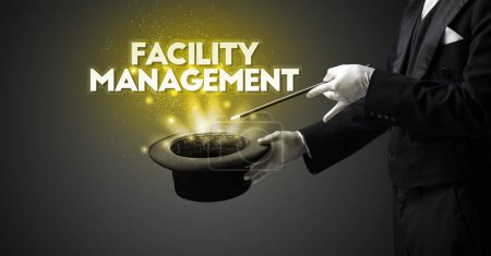 Photo for Illusionist is showing magic trick with FACILITY MANAGEMENT inscription, new business model concept - Royalty Free Image