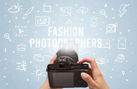 Photo for Hand taking picture with digital camera and FASHION PHOTOGRAPHERS inscription, camera settings concept - Royalty Free Image