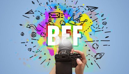 Foto de Primer plano de una cámara digital de mano con dibujo abstracto e inscripción BFF - Imagen libre de derechos