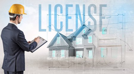 Photo for Young engineer holding blueprint with LICENSE inscription, house planning concept - Royalty Free Image
