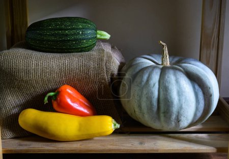 Photo for Pumpkins, vegetable marrow and sweet pepper in kitchen, vintage still life of organic food. Photo of zucchini on shelves in rustic home interior. Thanksgiving, harvest, farm, season, nature concept. - Royalty Free Image