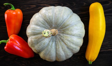 Photo for Vegetable marrow, pumpkin and sweet pepper on dark wooden table, top view. Still life of organic food, white pumpkin and zucchini, flat lay. Harvest, thanksgiving, nature, farm and squash concept. - Royalty Free Image