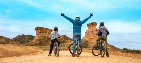 Photo for Happy family with mountain bike ( Monegros desert,  Huesca province in Spain) - Royalty Free Image