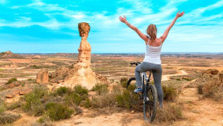Photo for Happy woman in bike,  Monegros desert,  Huesca province - Royalty Free Image