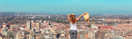 Photo for Happy woman in front of urban,  city landscape,  skyline - Royalty Free Image