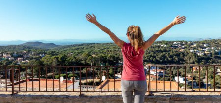 Photo for Happy woman at balcony looking at landscape view - Royalty Free Image