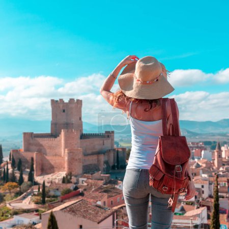 Photo for Woman tourist enjoying beautiful panoramic view of Atalaya castle,  Alicante province in Spain - Royalty Free Image