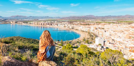 Photo for Woman tourist looking at panoramic view of Aguilas,  Murcia province in Spain - Royalty Free Image