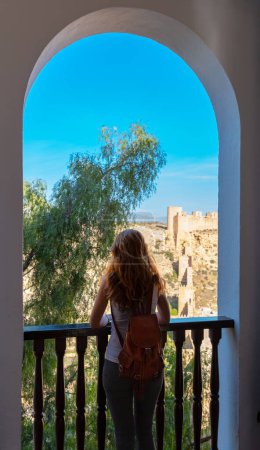 Foto de Woman looking at window alcazaba of Almeria panoramic view- Andalusia in Spain - Imagen libre de derechos
