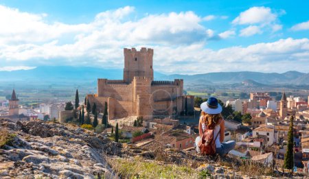 Photo for Woman tourist looking at Villena castle in Alicante province - Royalty Free Image
