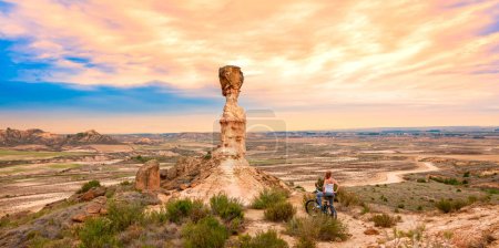 Photo for Monegros desert sandstone and woman on mountain bike- Spain - Royalty Free Image