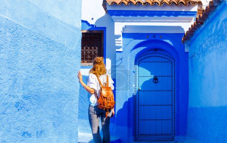 Téléchargez les photos : Femme touriste marchant dans la ville bleue de Chefchaouen, Maroc - en image libre de droit