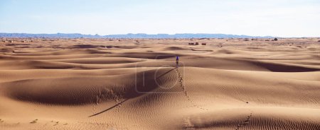 Photo for Tourist in the desert sand dunes in the sahara,  Morocco (Mhamid) - Royalty Free Image