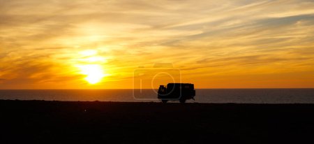 Photo for Adventurous road trip in motor home truck- sunset at the beach - Royalty Free Image