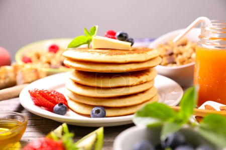 Photo for Pancakes with fresh berries fruits, blueberries, strawberries and maple syrup - Royalty Free Image