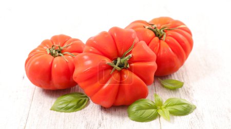 Photo for Red tomato and basil leaves - Royalty Free Image