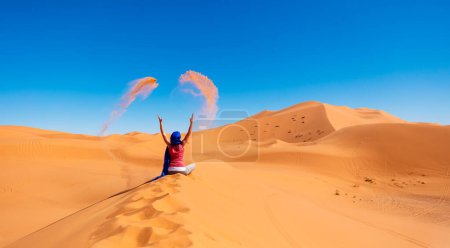 Photo for Woman in the desert threw sand- Morocco - Royalty Free Image