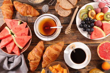 Photo for Healthy eating- breakfast with coffee and tea, fresh fruits and croissant - Royalty Free Image