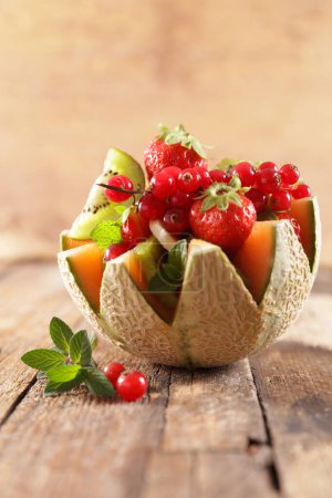 Photo for Mixed fruit salad in melon bowl - Royalty Free Image